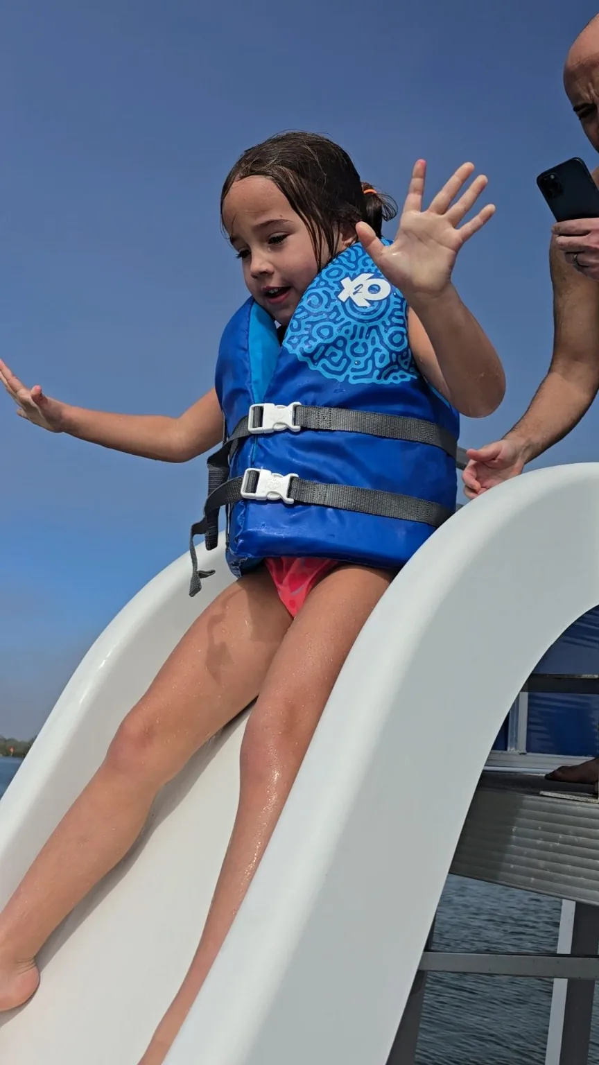 Young guest enjoying the waterslide on the Aquaholic Funship